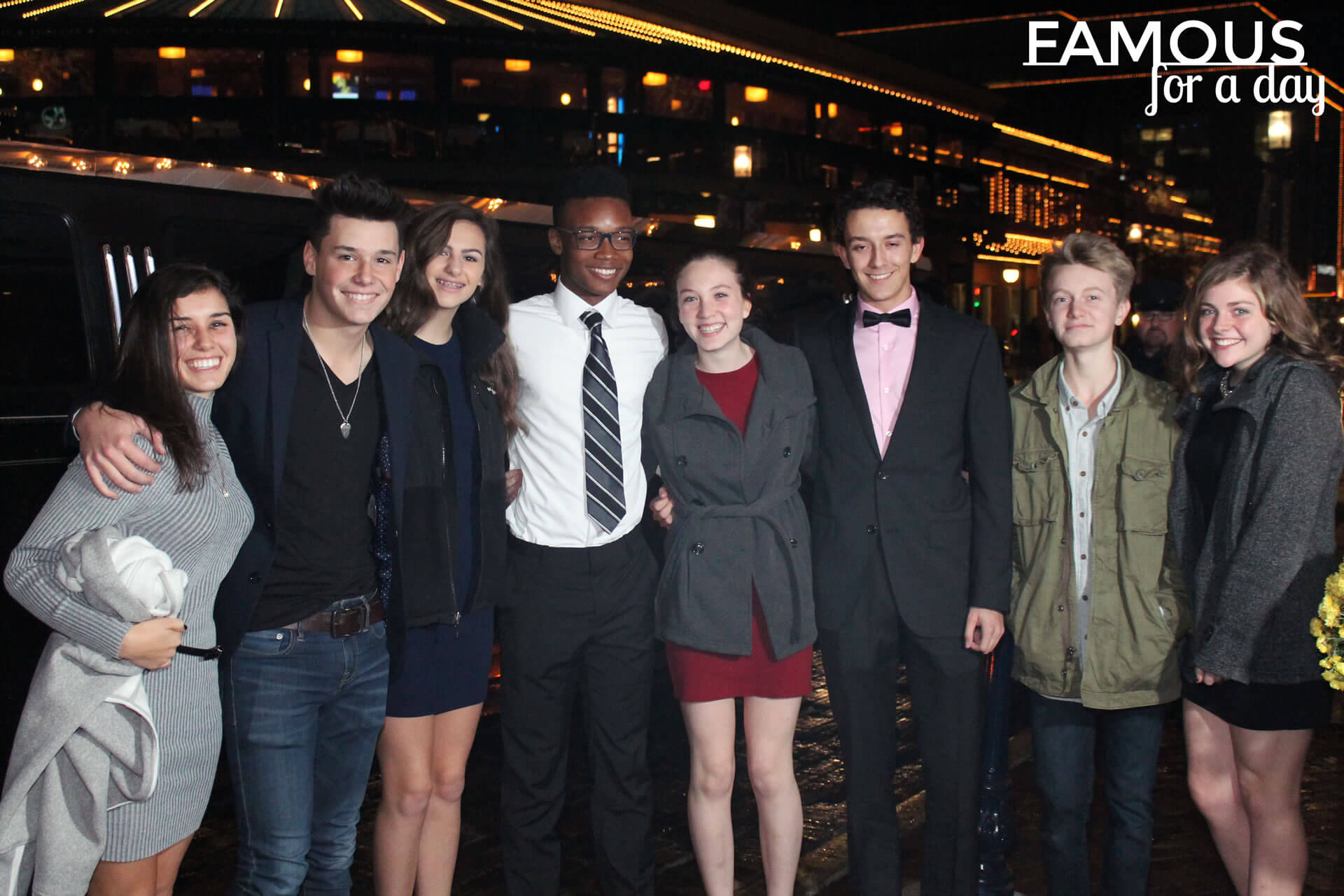 Guest smiling confidently as photographers capture images during a celebrity-style event
